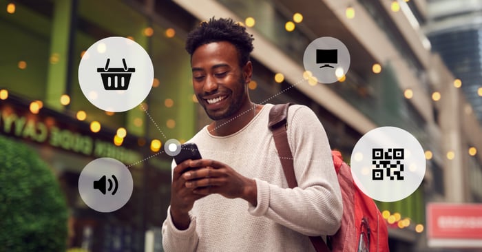 Guy shopping on his phone using omnichannel touchpoints