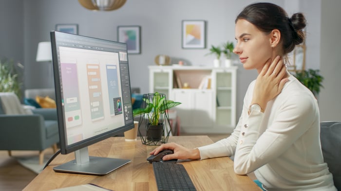 Brand marketer at computer working on mobile UI